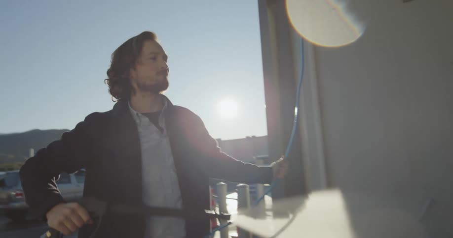 A man pressure washes his car thoroughly at a selfservice car wash