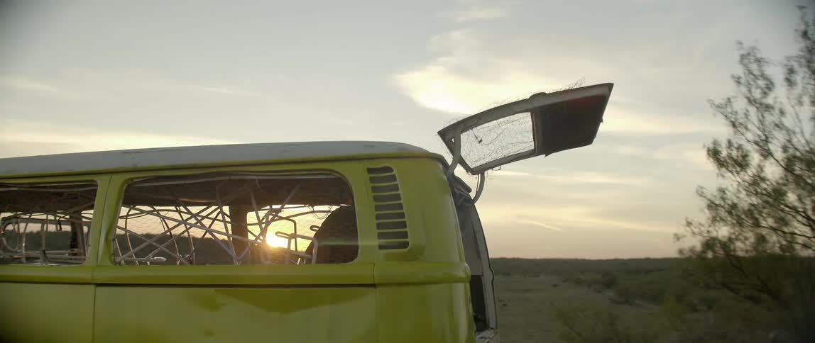 A person is in the back of this yellow van working