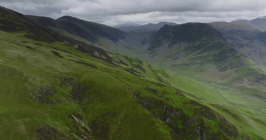 Mist covers mountains on horizon under a heavily clouded sky