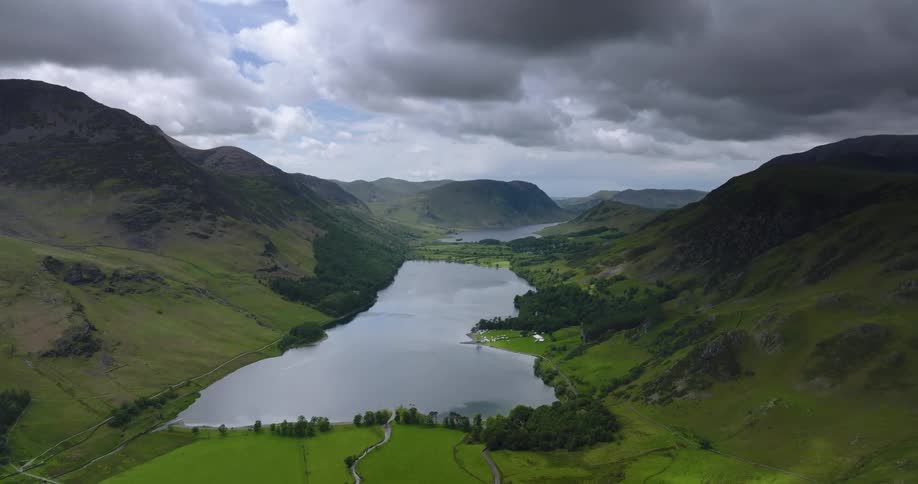 A lake on the floor of a verdant mountain valley on a cloudy day