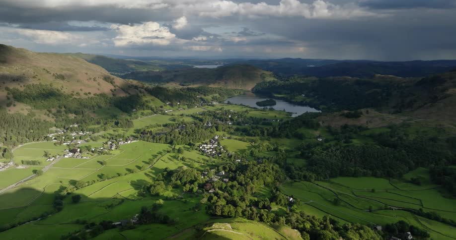 An aerial view of farmland hills and a lake