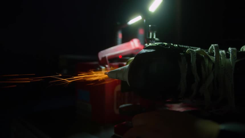 Sparks fly as a person sharpens hockey skates