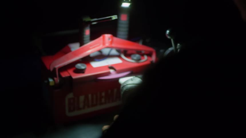 A man uses a device to sharpen his miter saw