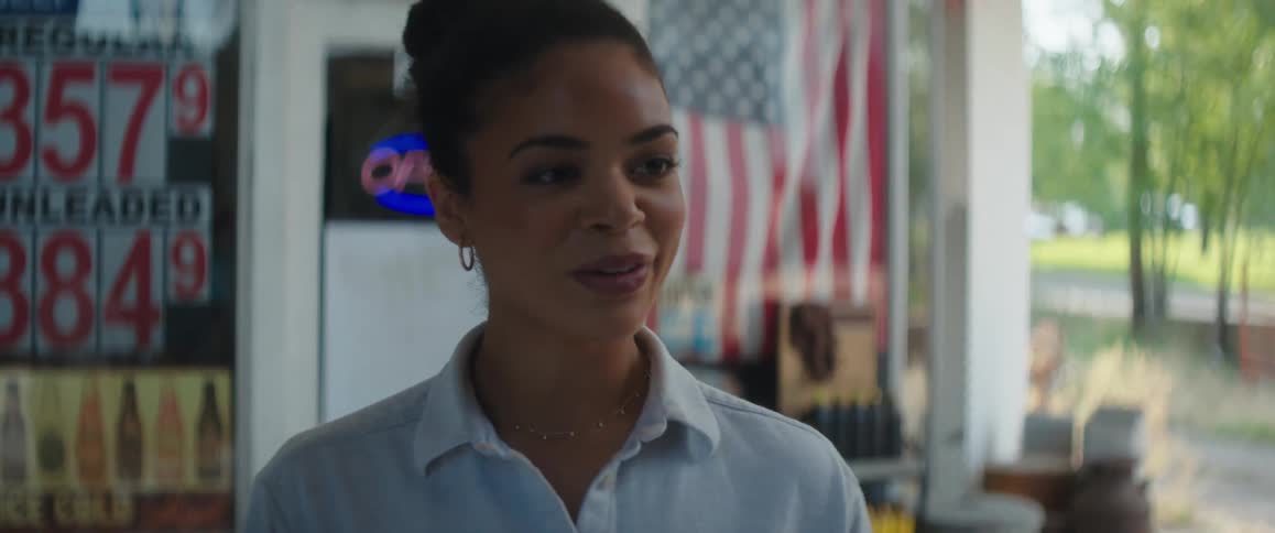 Young woman coming out of a small town store smiles and walks away