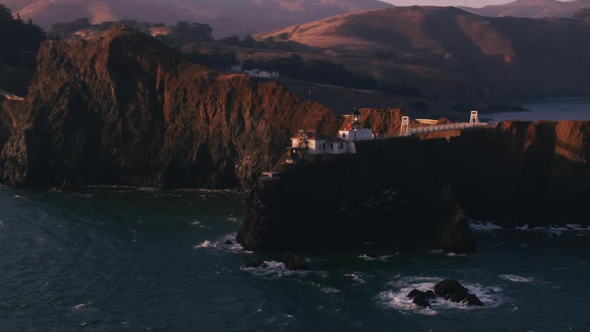 A building on a cliff overlooking the ocean during the day