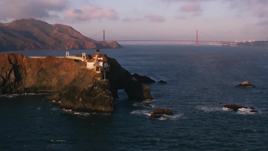 Aerial view of buildings over a promontory in front of the san francisco bridge