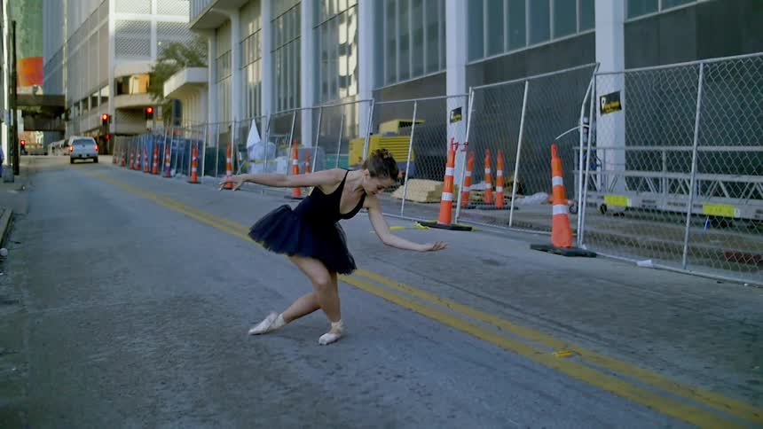 A woman takes a bow in the street
