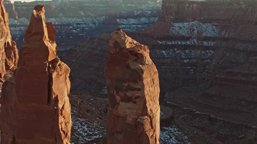 A dusting of snow covers the side of a canyon