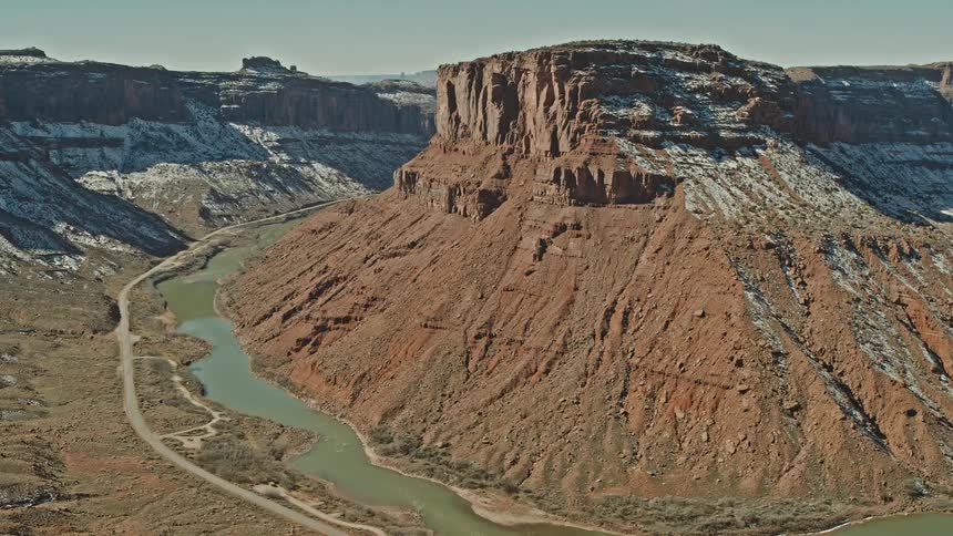 A river winds through the base of a canyon