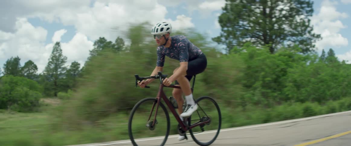 A man rides his bicycle through the countryside