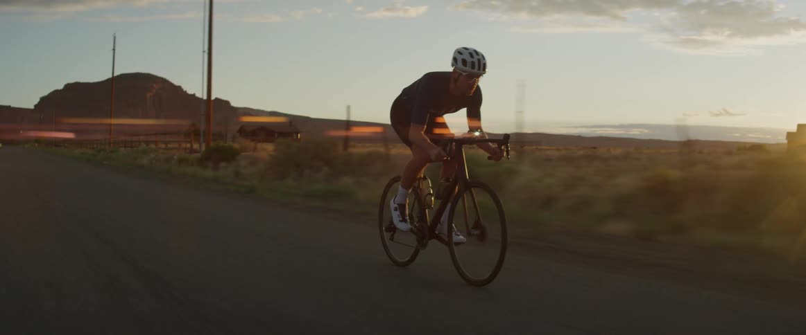 A man is riding his bike on the road