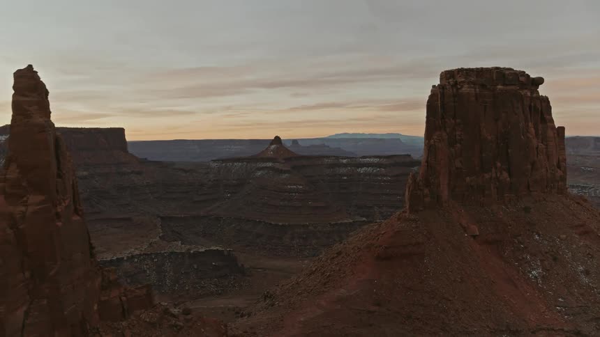 A vast canyon is filled with tall mesas with both flat and pointed summits
