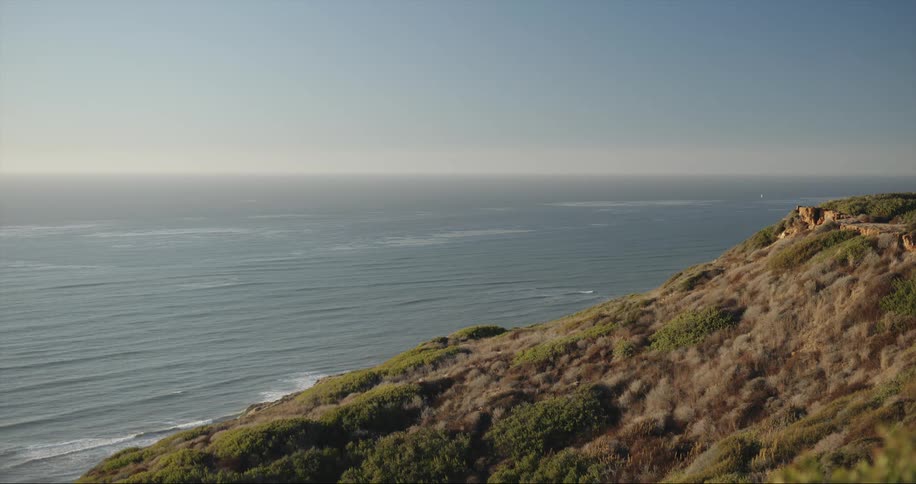 Promontory overlooks ocean as waves roll toward shore