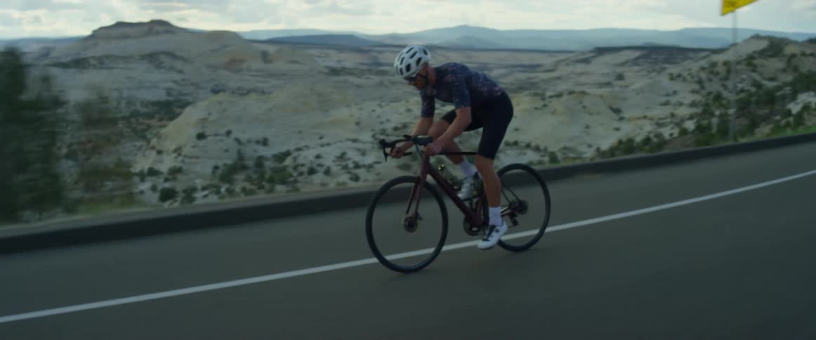 A man rides his bicycle past a quarry