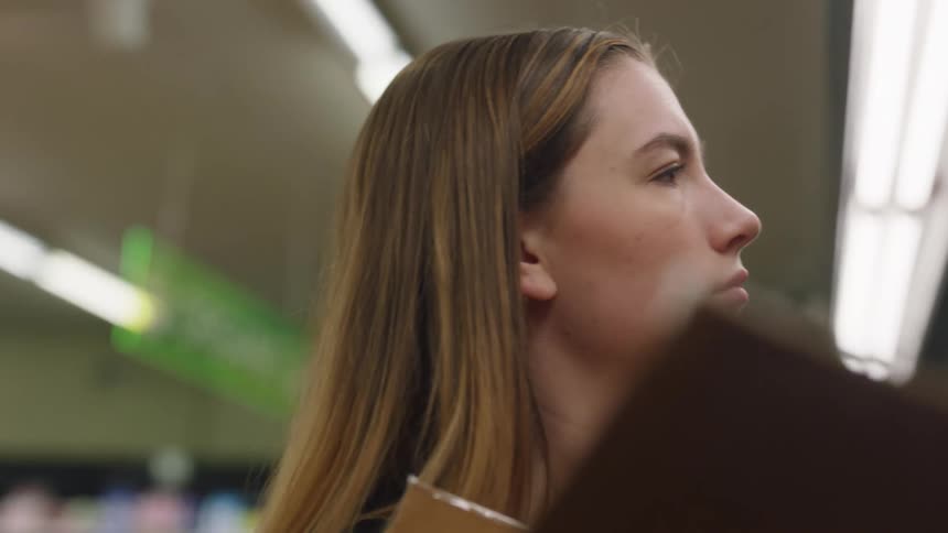 A woman stocking shelves at the grocery store