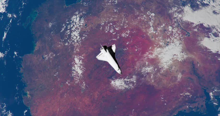 The space ship is floating above the red continent on planet earth