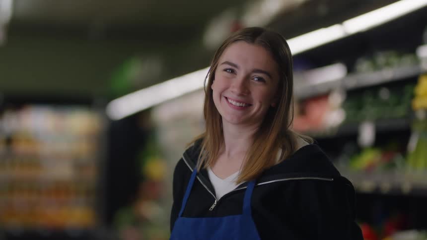A worker smiles in the grocery shore