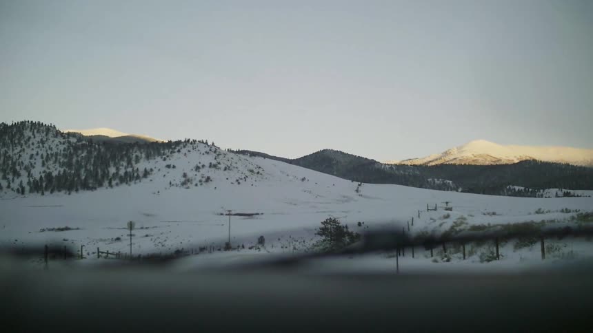 Traveling down a road surrounded by mountains and snow