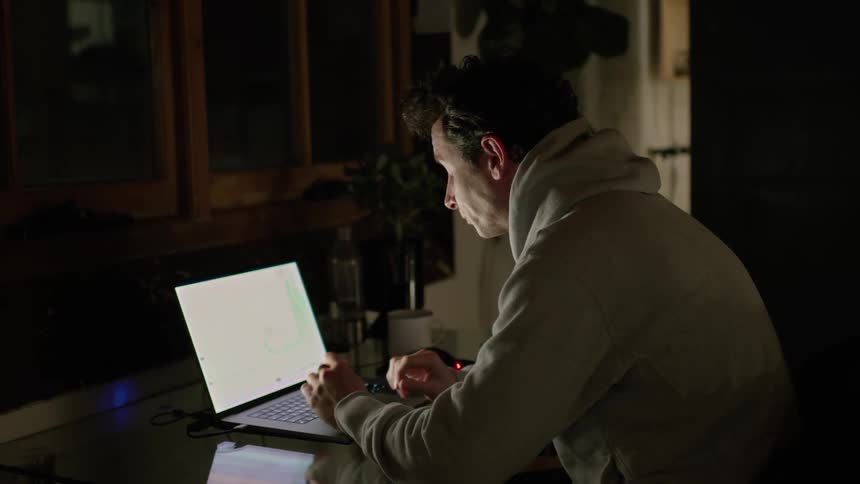 A view of a man using a laptop