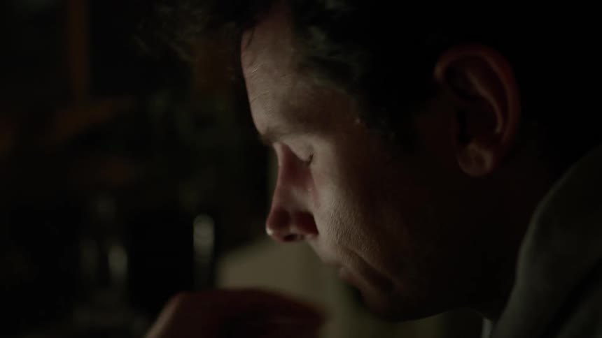 A man rubs his eyes