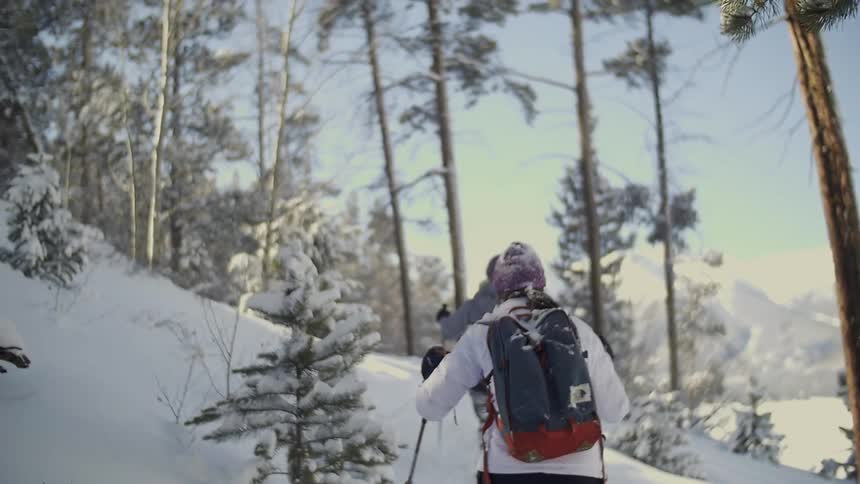 Two people are traveling in deep snow uphill