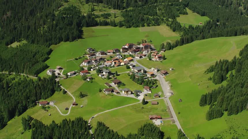A small town in a hilly countryside during the day