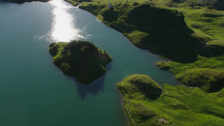 Aerial view of a small island covered in lush green vegetation on a lake