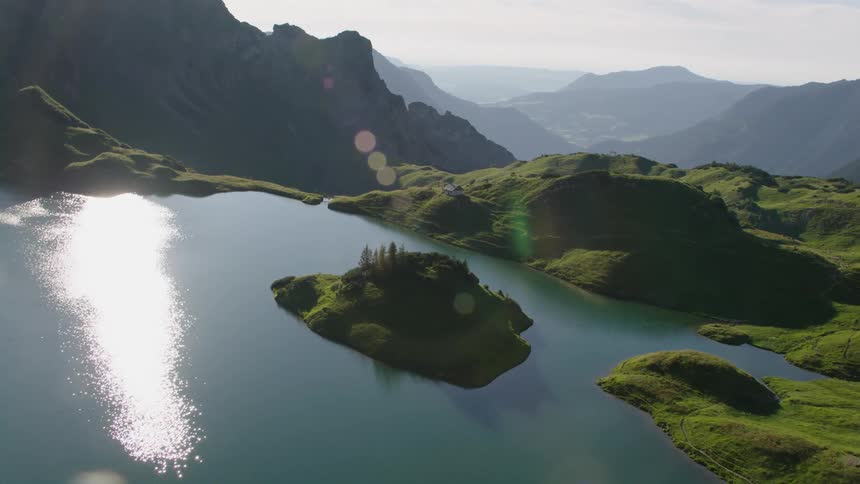 Aerial view of a small island covered in lush green vegetation on a lake