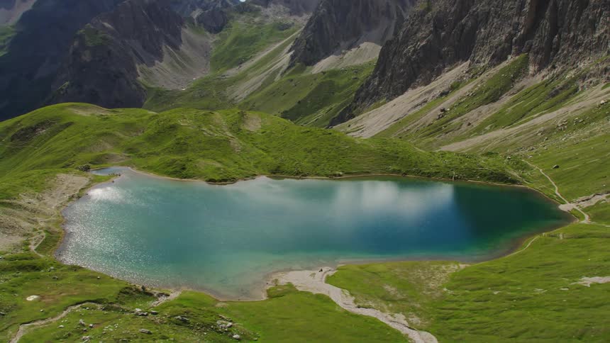 Aerial view of small lake between mountains
