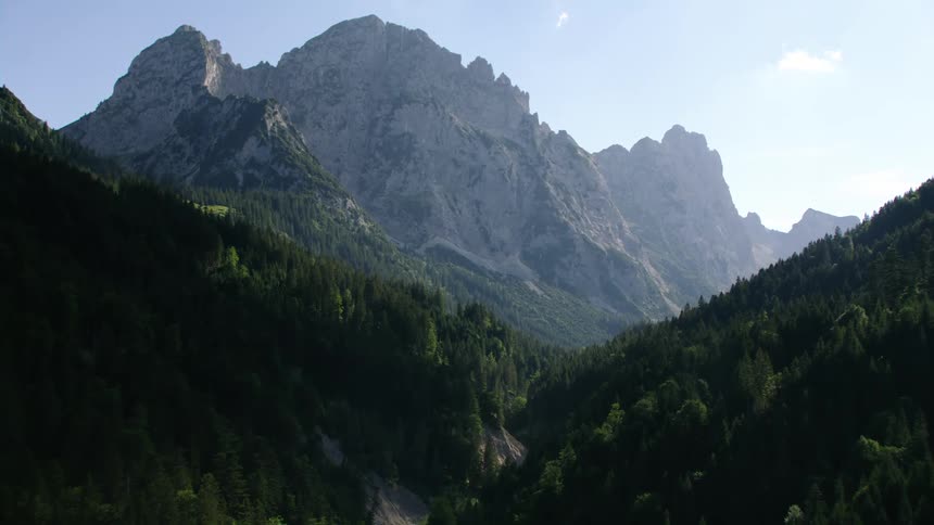 Aerial view of the tall peaks of a mountain range at morning