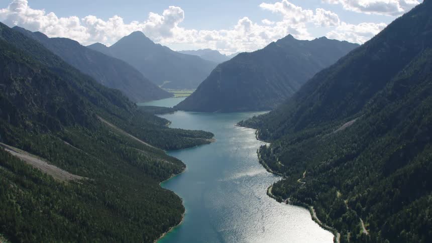 An aerial view of a river flowing between hills