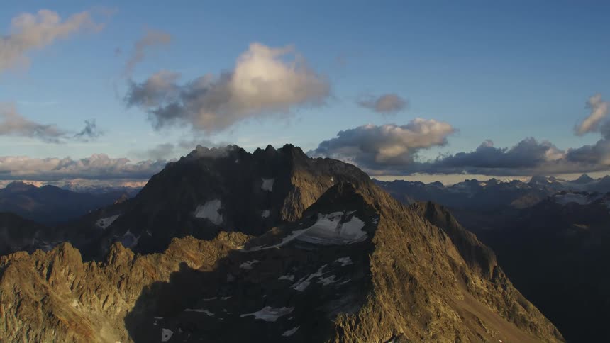 Aerial view of high mountain peaks and clouds