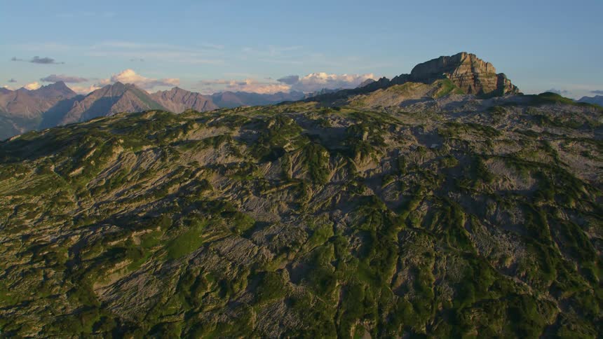 Aerial view of the rugged slopes of a mountain peak at morning