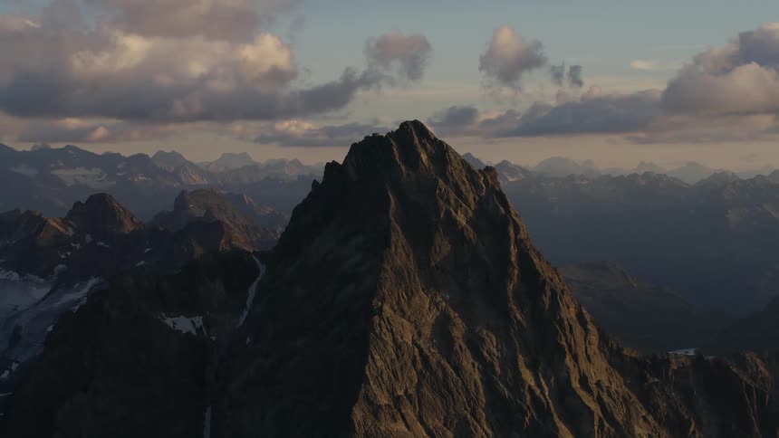 Aerial view of the rugged slopes of a mountain peak at morning