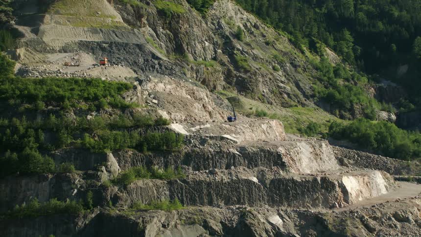 Equipment and a worker on the steep slate quarry sections