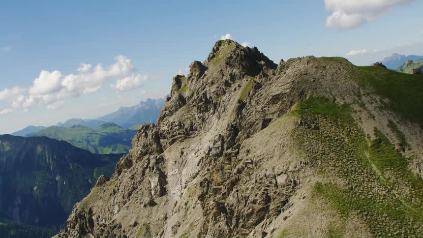 Twisting aerial view of the summit of a mountain range at morning