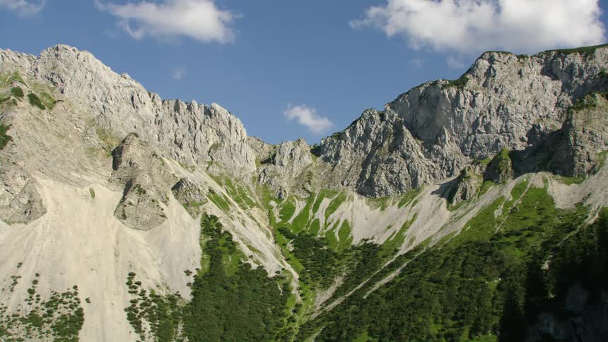 Aerial view of rocky mountains under blue sky