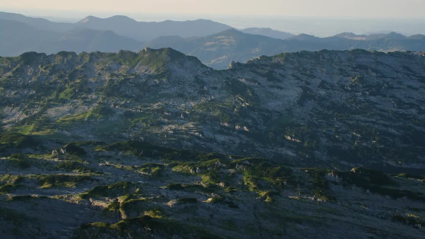 A jagged and rocky mountain range spans a great distance