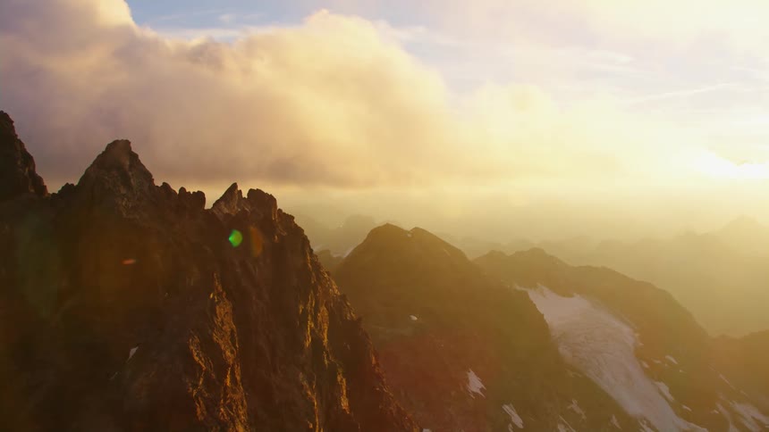 Aerial view of high mountains while the sun shining bright