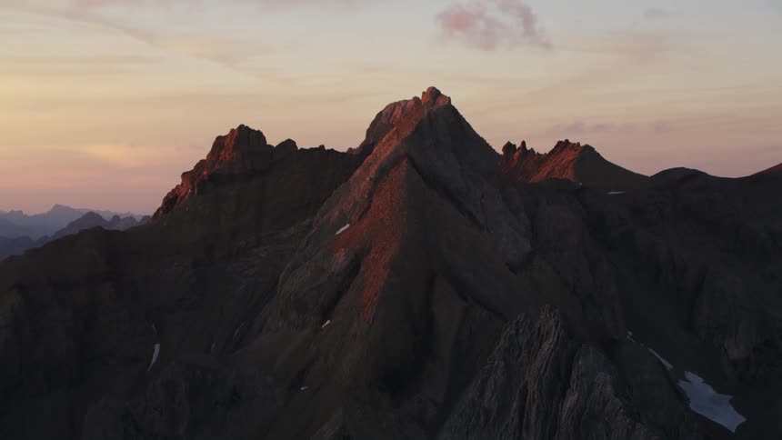 Aerial view of high mountain peak at sunset