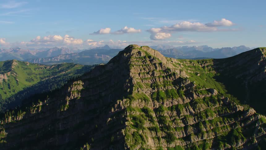 Aerial view of the rugged slopes of a mountain peak at morning