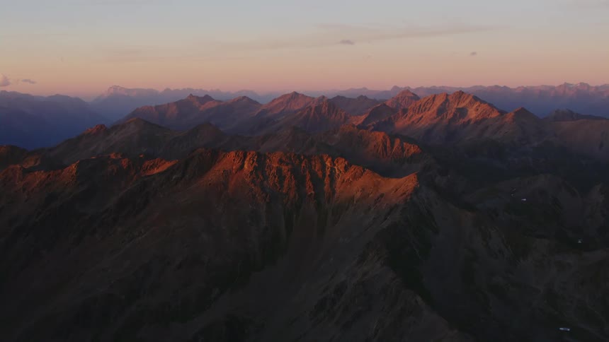 Aedrial view of the rugged rock slopes of a mountain range at evening