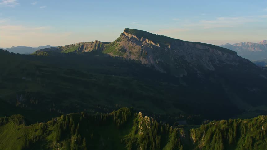 Aerial view of the rugged slopes of a mountain peak at morning