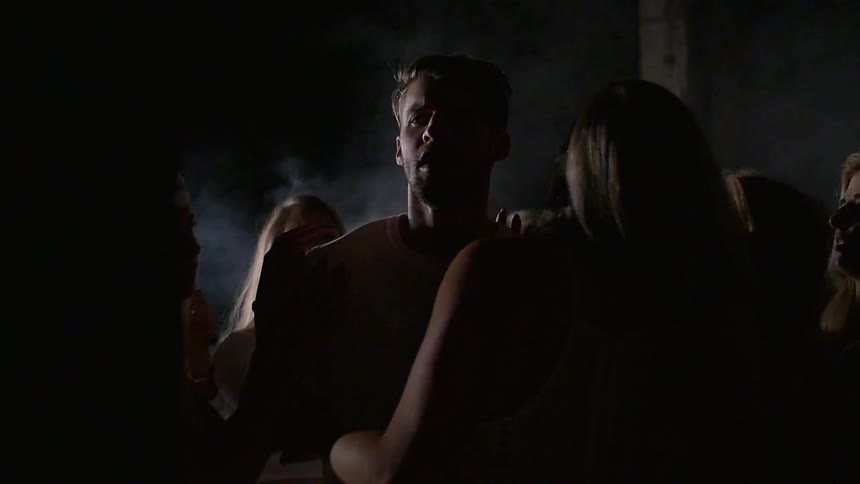 Women circle around a man and touch him