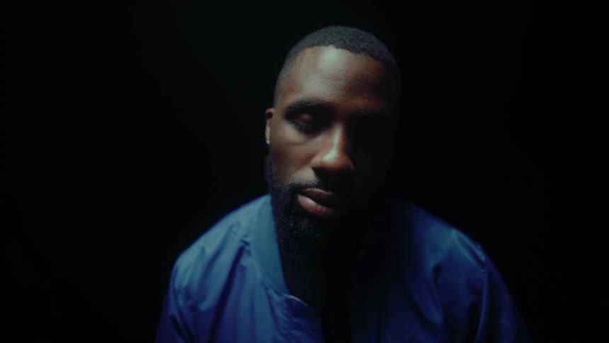 Man standing with his eyes closed sways in darkness