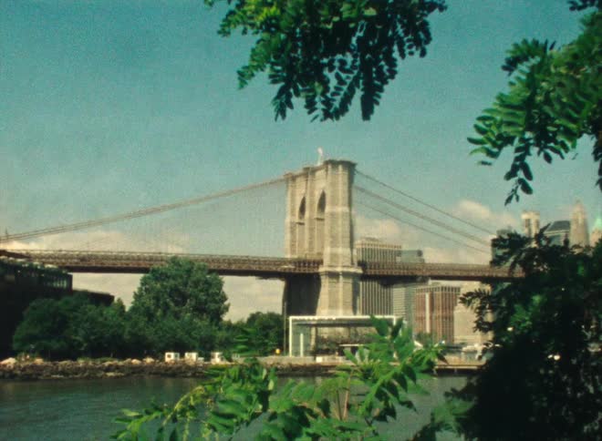 Traffic moves across a bridge as automobiles travel over the water