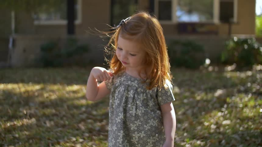 A girl looks at a woman on a sunny day