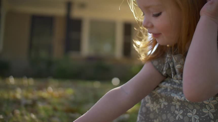 A little girl playing outside