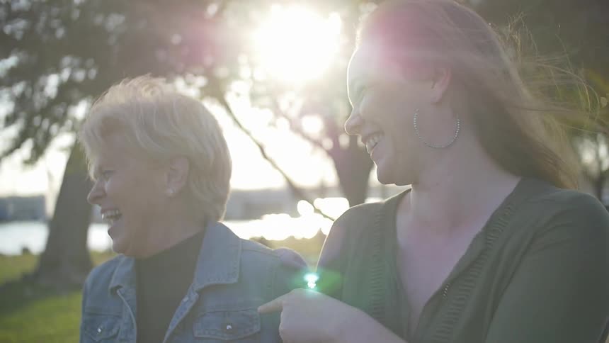 Two women talk and laugh as they walk