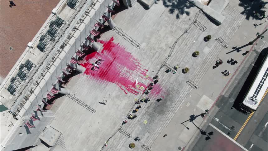 Protesters spilled paint down stairs in a city